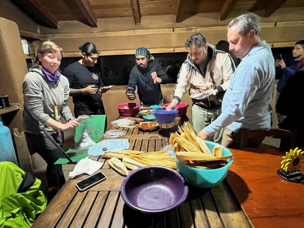 cooking class working together to make Tamales in the Sierra Norte, Oaxaca, Mexico