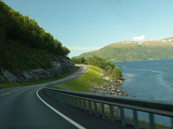 road next to a waterway, ideal for a roadtrip