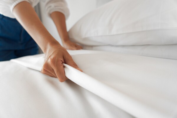 making the bed with quality bed sheets